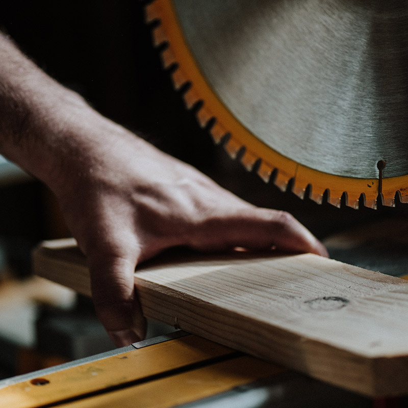 saw-cutting-hardwood-flooring-plank Saw cutting through hardwood flooring plank